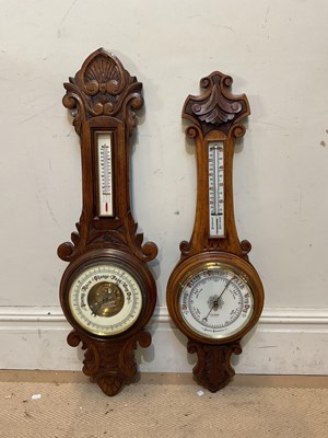 Lot 1288 - Two early 20th century carved oak aneroid...