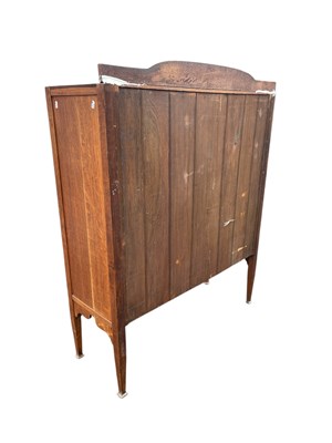 Lot 11 - An Arts and Crafts light oak bookcase with...