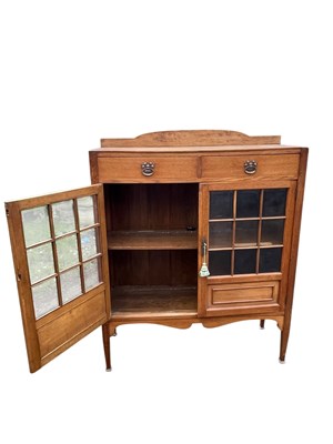 Lot 11 - An Arts and Crafts light oak bookcase with...