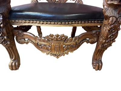 Lot 37 - A reproduction Continental carved hardwood and...
