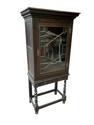 Lot 1169 - A dark oak display cabinet, the moulded...