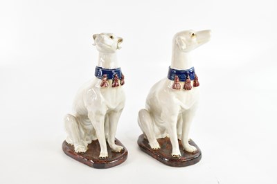 Lot 1576 - A pair of modern models of seated greyhounds,...