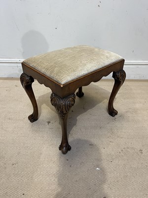 Lot 1253 - A George II style carved walnut stool, with...