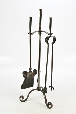 Lot 2406 - A steel three piece companion set, on stand...