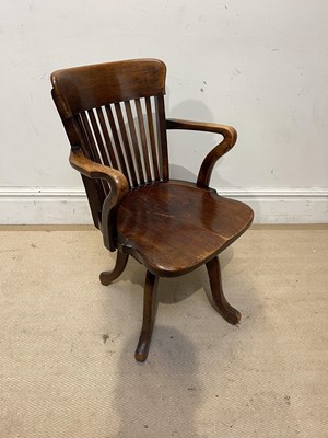 Lot 1229 - An Edwardian beech swivel desk chair, on four...