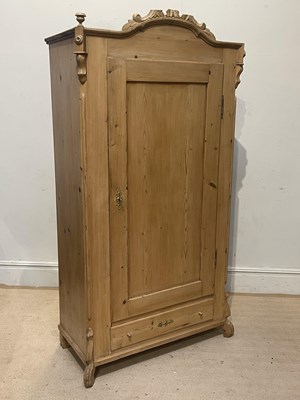 Lot 1041 - A French pine armoire, with carved cornice...