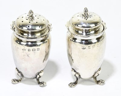 Lot 2420 - A pair of Edwardian hallmarked silver peppers,...