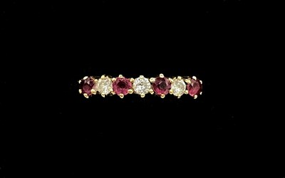 Lot 1293 - An 18ct yellow gold ruby and diamond seven...