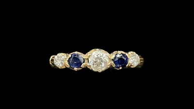 Lot 1295 - A yellow metal sapphire and diamond five stone...