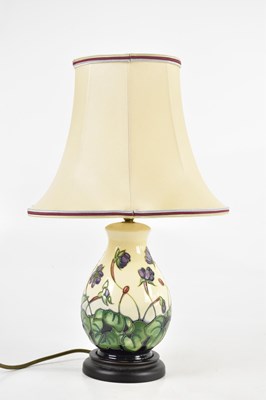 Lot 1446 - MOORCROFT; a decorative modern table lamp of...