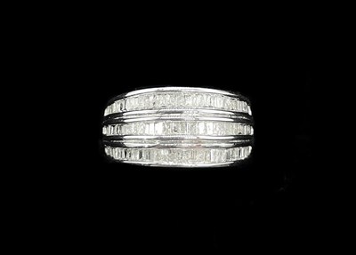 Lot 1299 - A silver three row diamond set dress ring,...