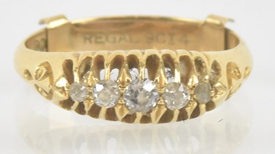 Lot 1247 - An 18ct yellow gold five stone diamond ring,...