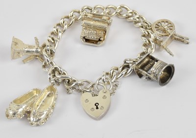 Lot 1351 - A 925 hallmarked silver charm bracelet, with...