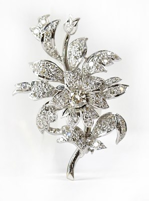 Lot 843 - A white metal brooch in the form of flower and...