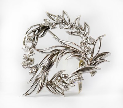 Lot 840 - An 18ct white gold circular brooch in the form...