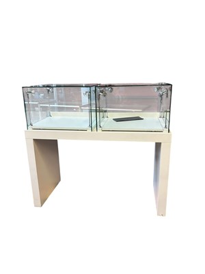 Lot 1102 - Two modern white finished and glass jewellery...