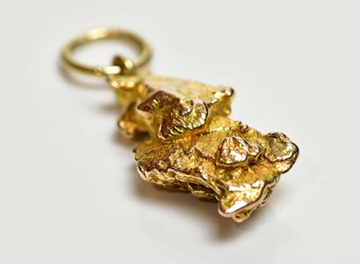 Lot 8 - A yellow metal nugget pendant, with simple...