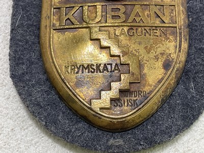 Lot 45 - A small collection of German badges and a cap,...