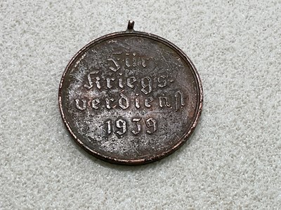 Lot 45 - A small collection of German badges and a cap,...