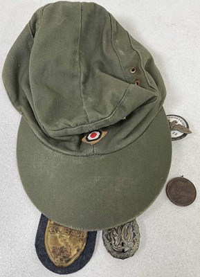 Lot 45 - A small collection of German badges and a cap,...