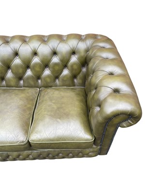 Lot 30 - A green leather three seater Chesterfield sofa,...