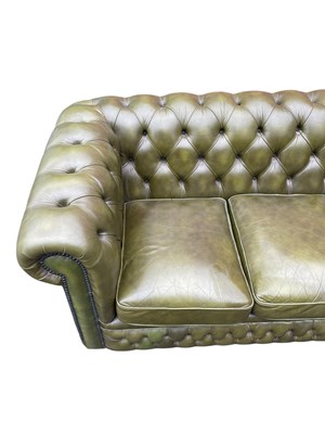 Lot 30 - A green leather three seater Chesterfield sofa,...