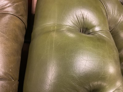 Lot 30 - A green leather three seater Chesterfield sofa,...