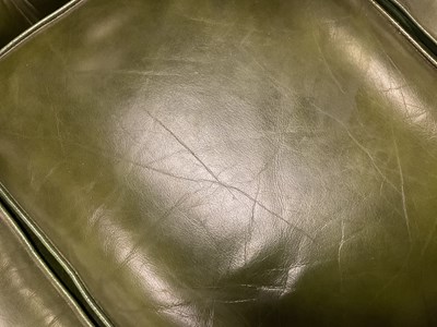 Lot 30 - A green leather three seater Chesterfield sofa,...