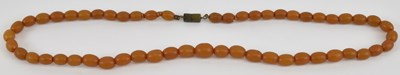 Lot 1232 - A small amber bead effect necklace, length...