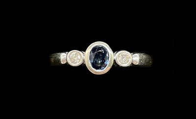 Lot 1272 - An 18ct white gold sapphire and diamond three...