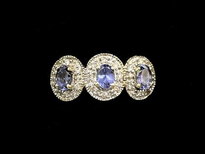 Lot 1275 - A 14ct yellow gold tanzanite and diamond three-...
