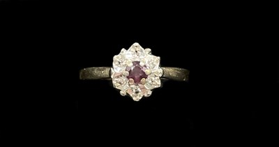 Lot 1276 - A yellow metal ruby and diamond chip flower...