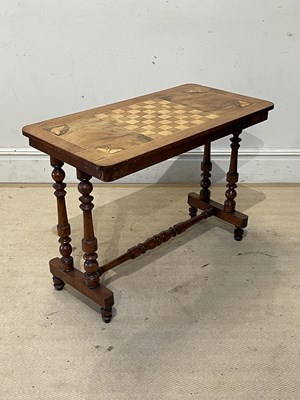 Lot 1252 - A Victorian walnut rectangular games table...