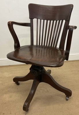Lot 432 - An early 20th century oak swivel office chair,...