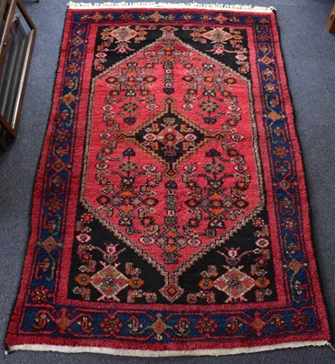 Lot 104 - A vintage 20th century Afghan rug with a...