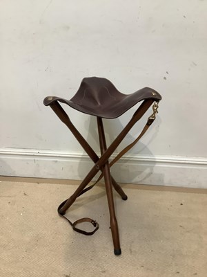 Lot 1012 - A modern folding shooting stool with leather...