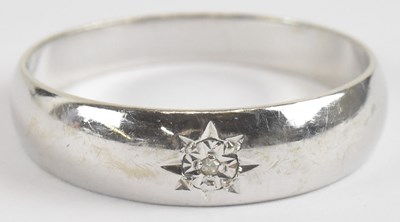 Lot 1305 - A 9ct gold diamond set band ring, size T,...
