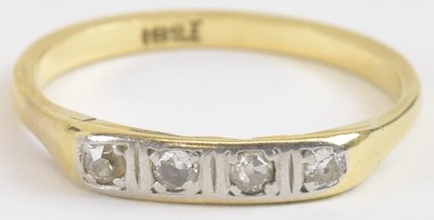 Lot 1306 - An 18ct gold four stone diamond set ring, size...