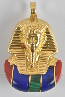 Lot 1483 - An Egyptian gold and enamel pendant depicting...