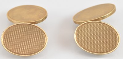 Lot 1377 - A pair of 9ct gold oval cufflinks, one face...
