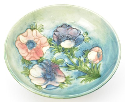 Lot 561 - WALTER MOORCROFT; a conical dish with tube...