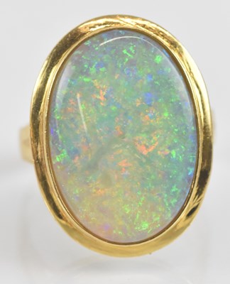 Lot 1233 - An 18ct gold opal ring, the large bezel set...
