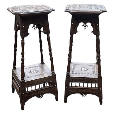 Lot 65 - A pair of Eastern two tier jardinière stands,...