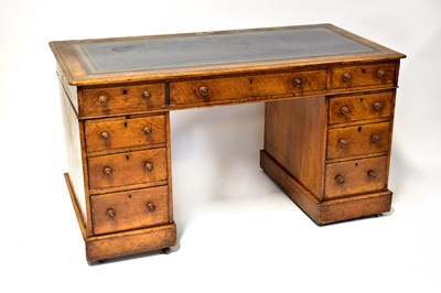 Lot 80 - An oak nine-drawer twin pedestal desk with a...