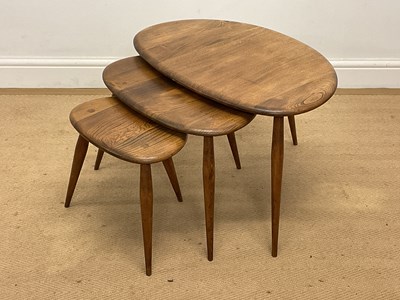 Lot 586 - ERCOL; a nest of three pebble tables in elm...