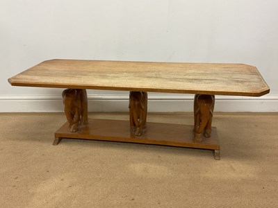 Lot 615 - A wooden coffee table with three carved...