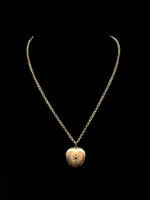 Lot 1210 - A 9ct yellow gold hoop link chain suspending a...