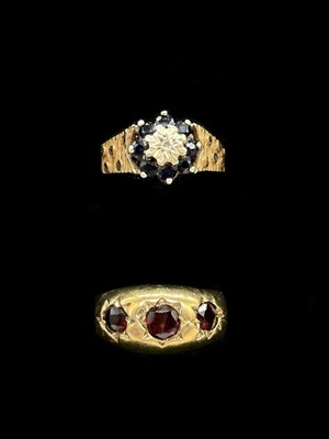 Lot 1213 - A 9ct yellow gold sapphire floral dress ring,...