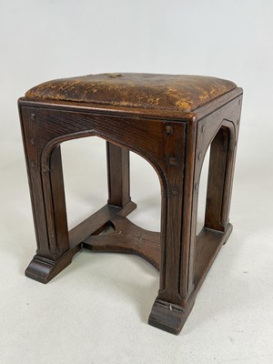 Lot 616 - A Gothic inspired oak stool, with visible stud...