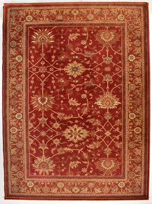 Lot 156 - A contemporary machine made red ground rug,...